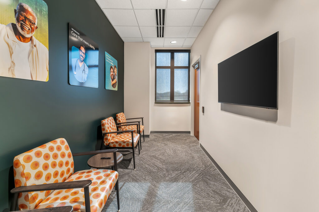 Infusion center lobby with chairs on the left and a tv on the right