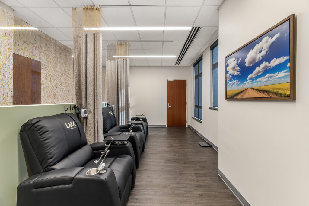 Shared infusion room with three comfy black chairs